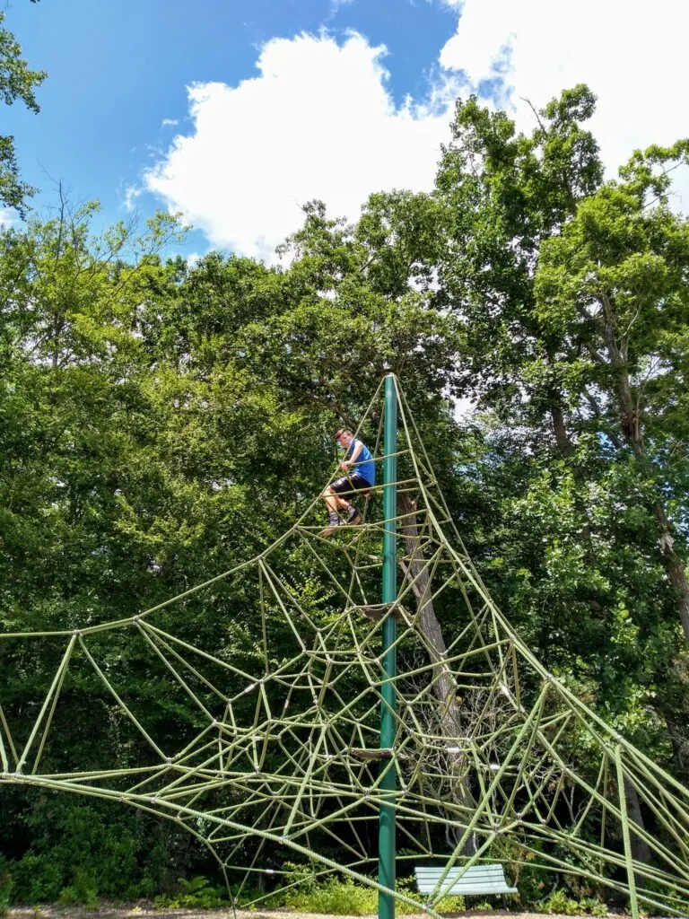 image of child at playground in the dinosaur place at nature's art village.