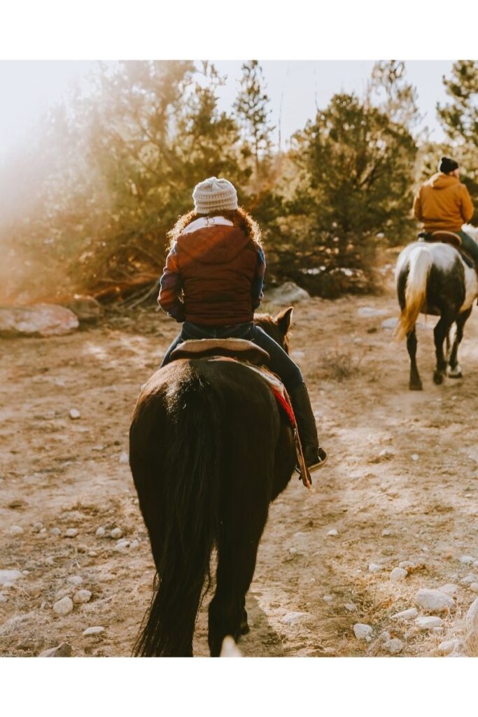 image of couple on horseback riding trail in ct.