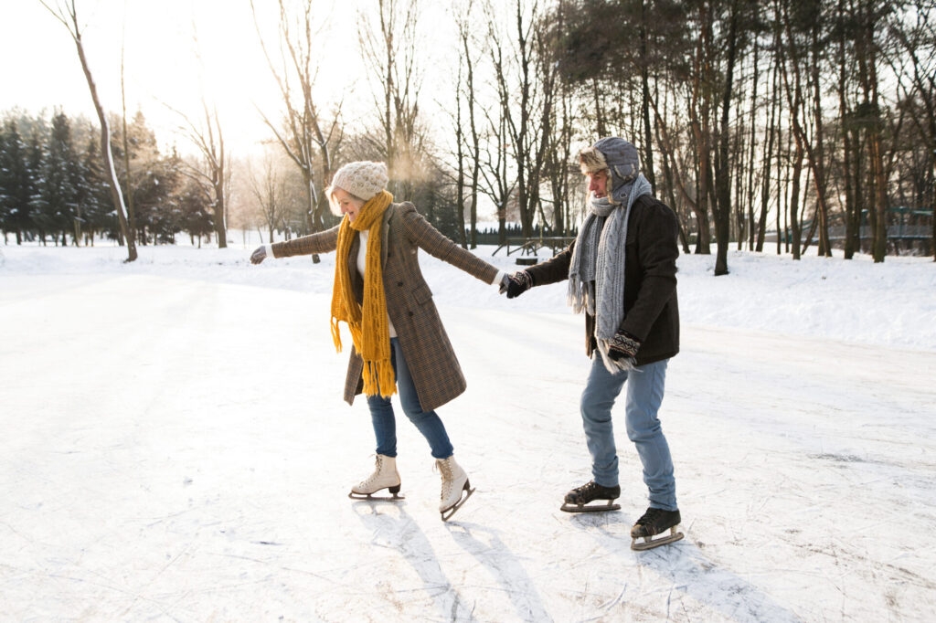 image of couple ice skating outdoors in connecticut.