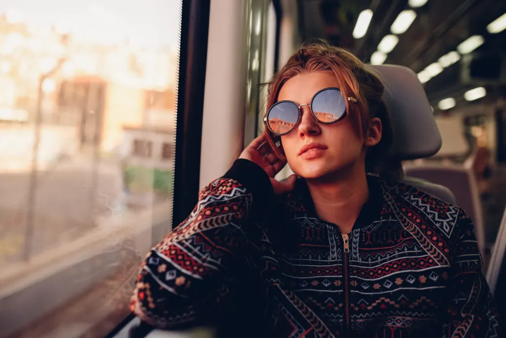 image of woman riding train from connecticut to new york city.