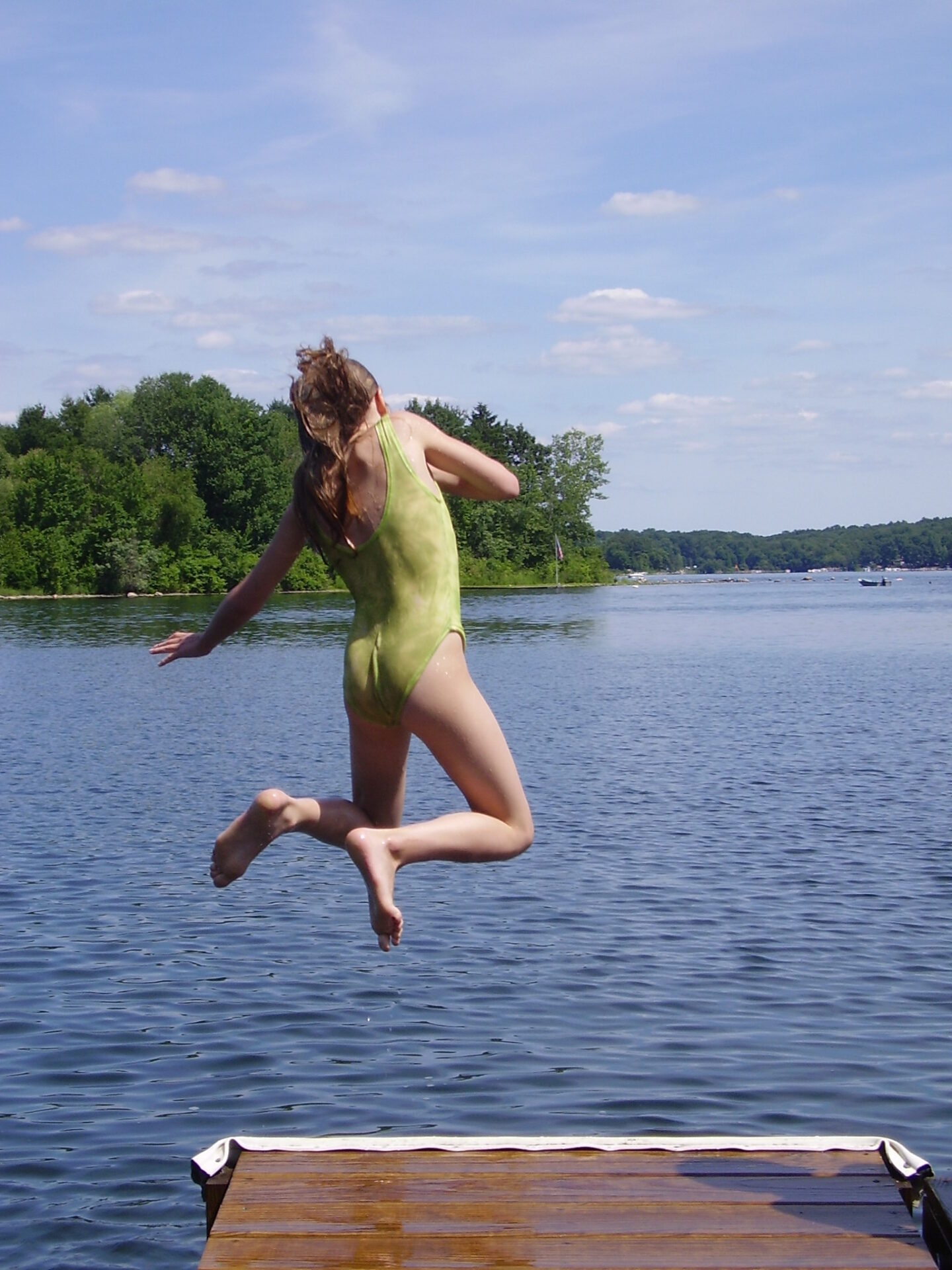 image of girl jumping in a Connecticut lake.