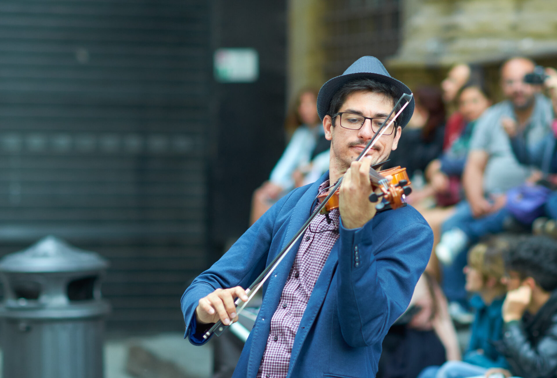 image of man playing violin in artsy town in Connecticut.