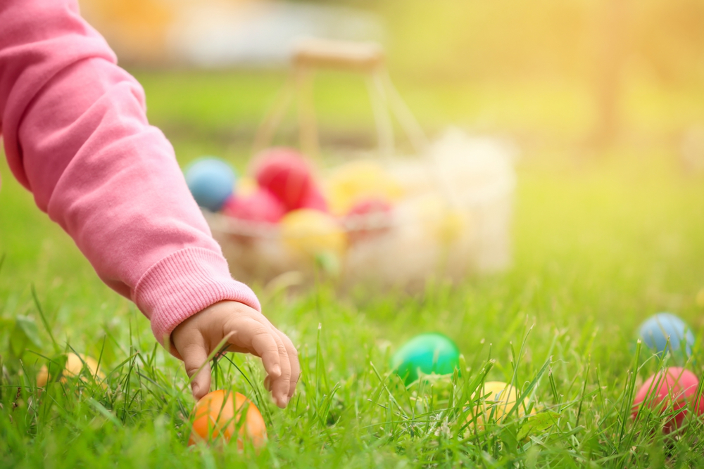 image of child picking up easter eggs.