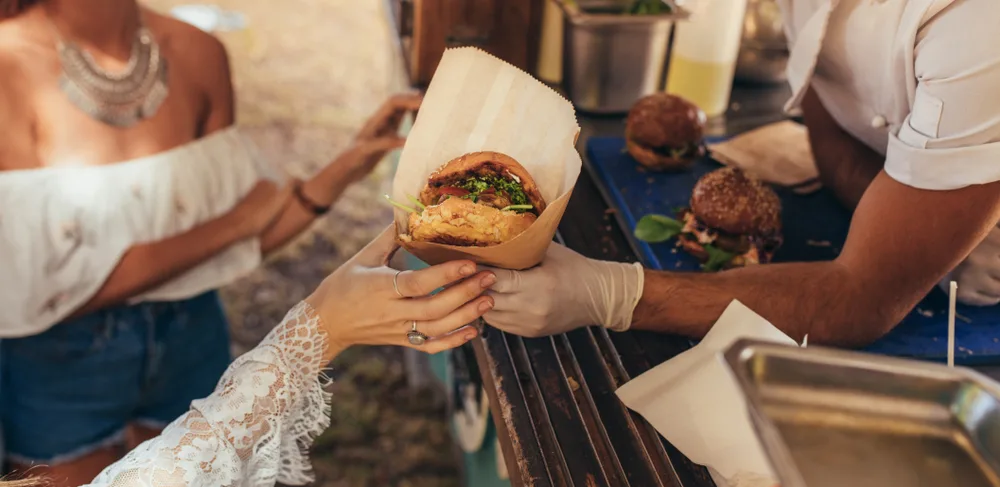 image of woman getting food from food trucks in new haven.