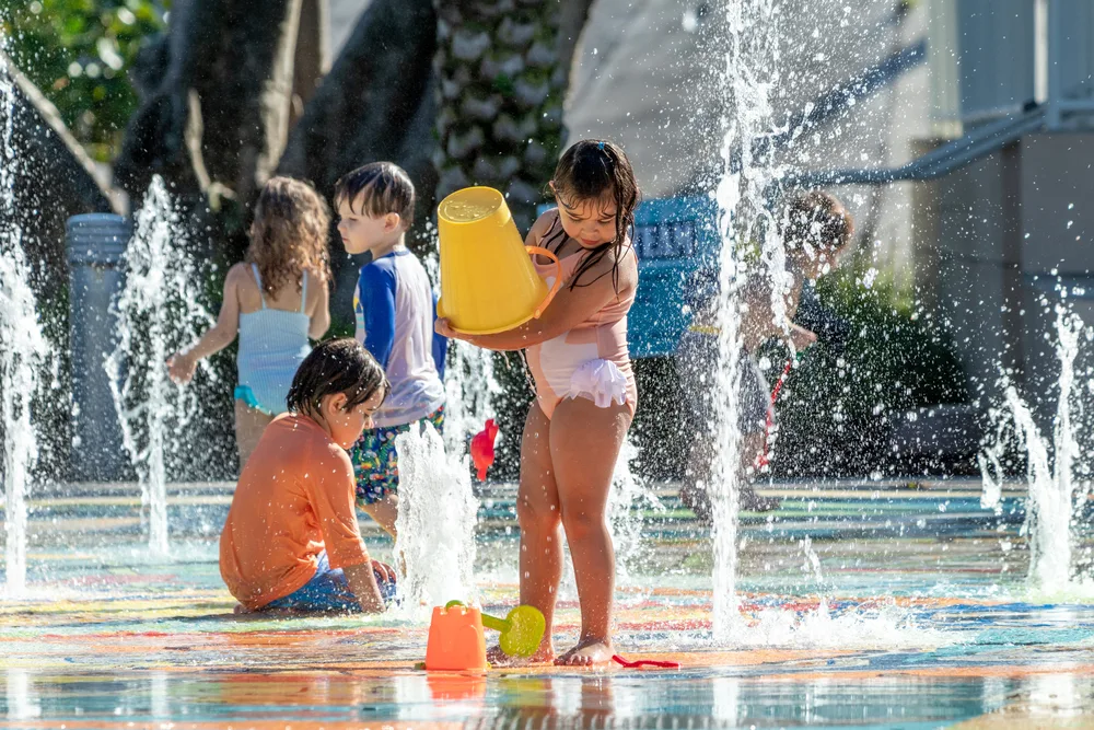 image of kids playing on splash pads inct.