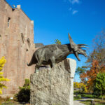 image of dinosaur statue outside of yale peabody museums in new haven ct.