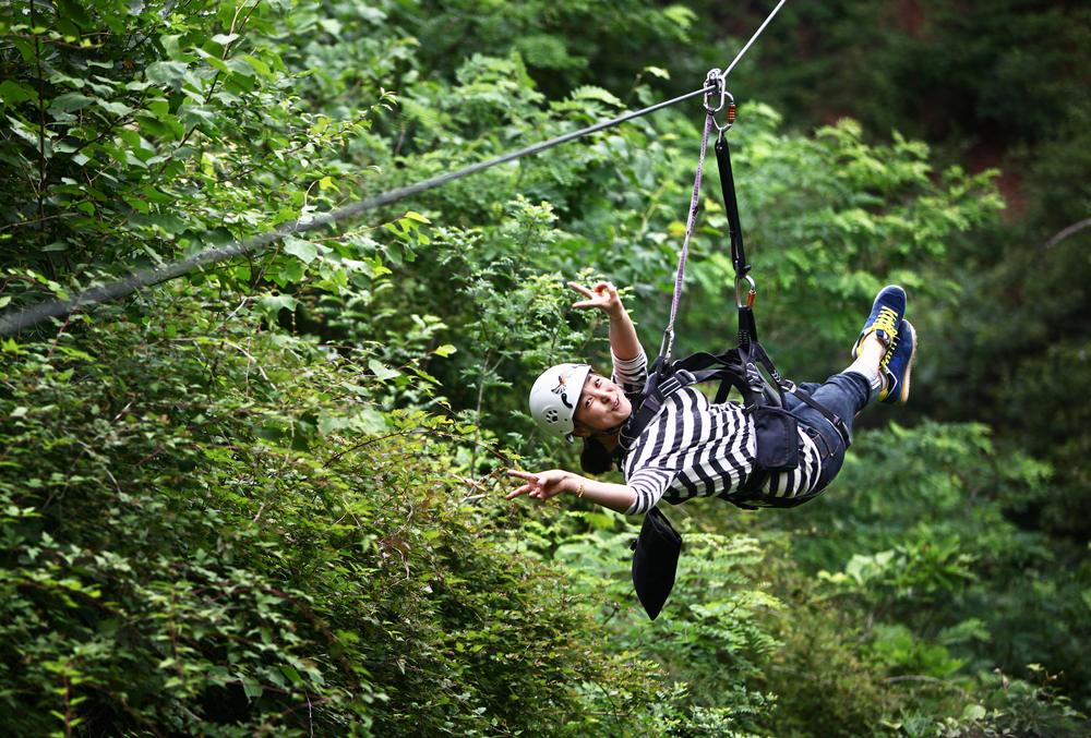 image of a woman ziplining in Connecticut.