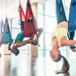 image of 3 people doing aerial yoga in CT yoga studio.
