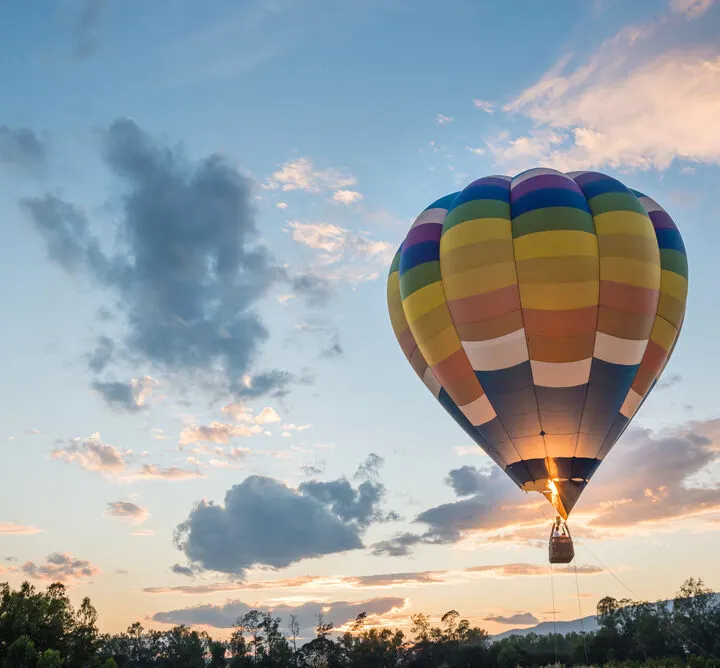 image of person taking hot air balloon ride in CT at sunset.