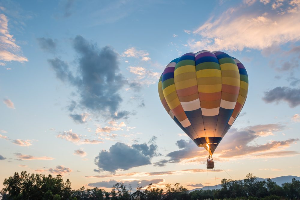 image of person taking hot air balloon ride in CT at sunset.