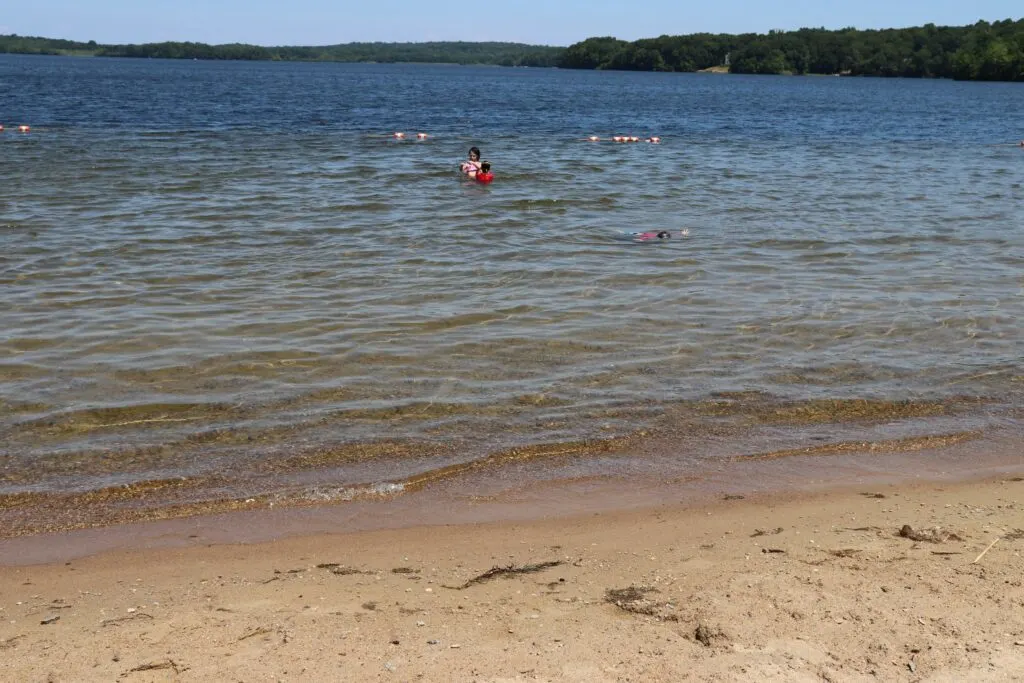 image of swimming beach at gardner lake in salem ct.