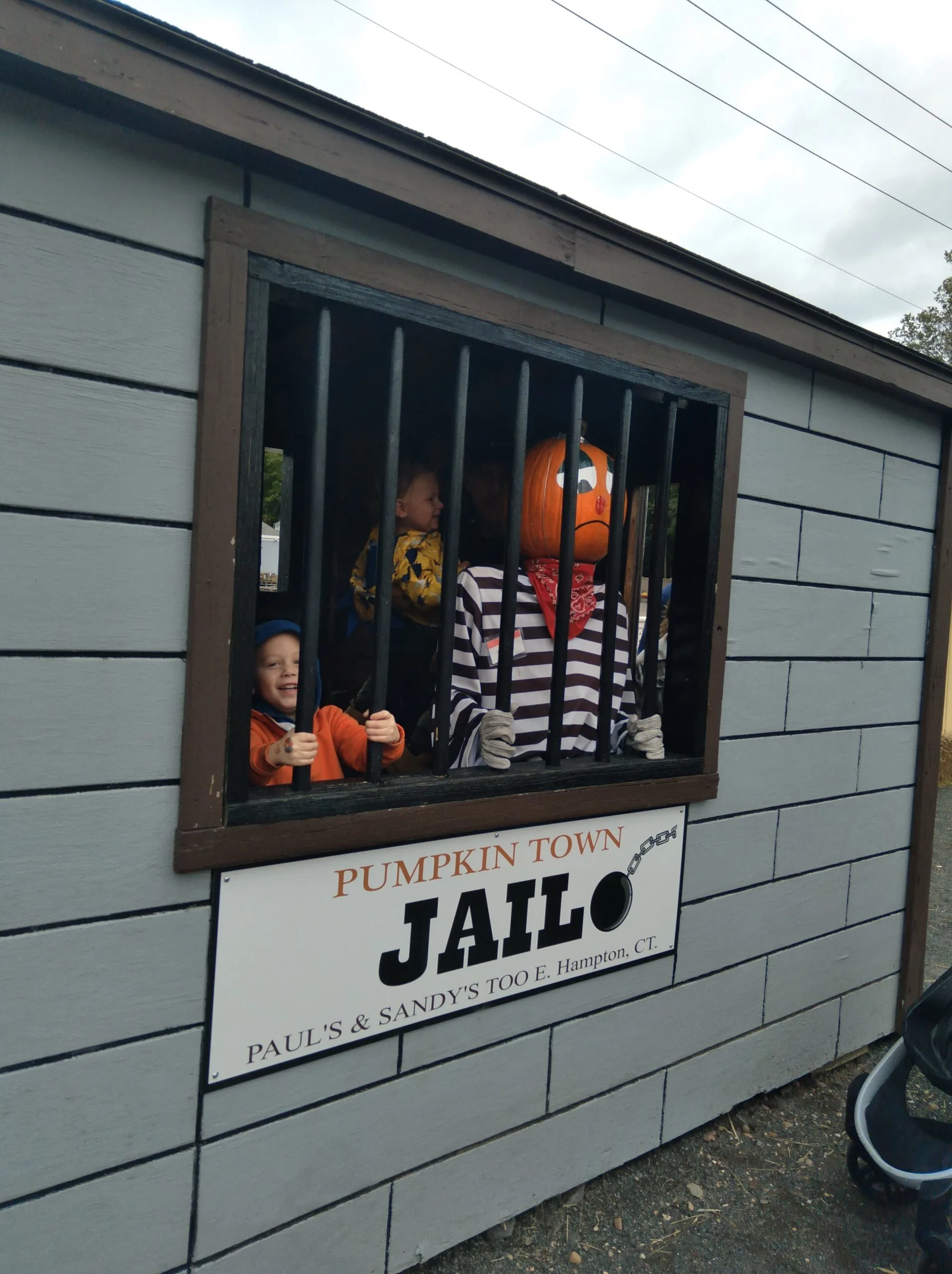 Image of child in pretend jail at pumpkintown usa in east hampton ct.