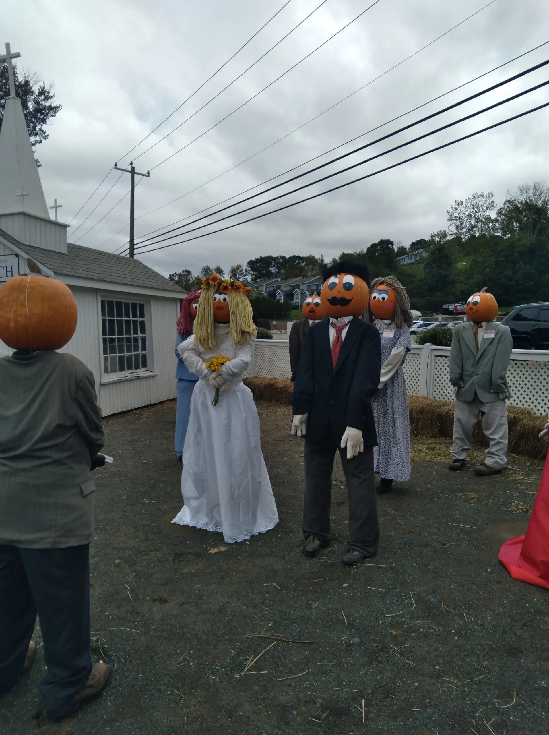 Image of people with pumpkin heads getting married in pumpkintown in ct.