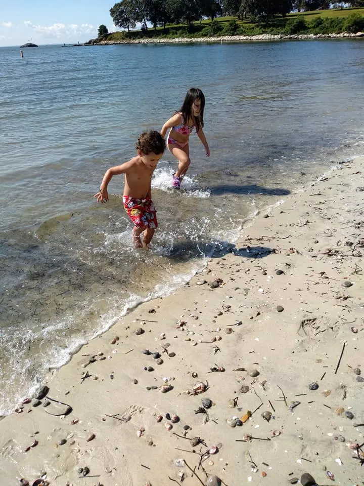 Image of 2 children Playing at Hole in wall Beach in Connecticut.