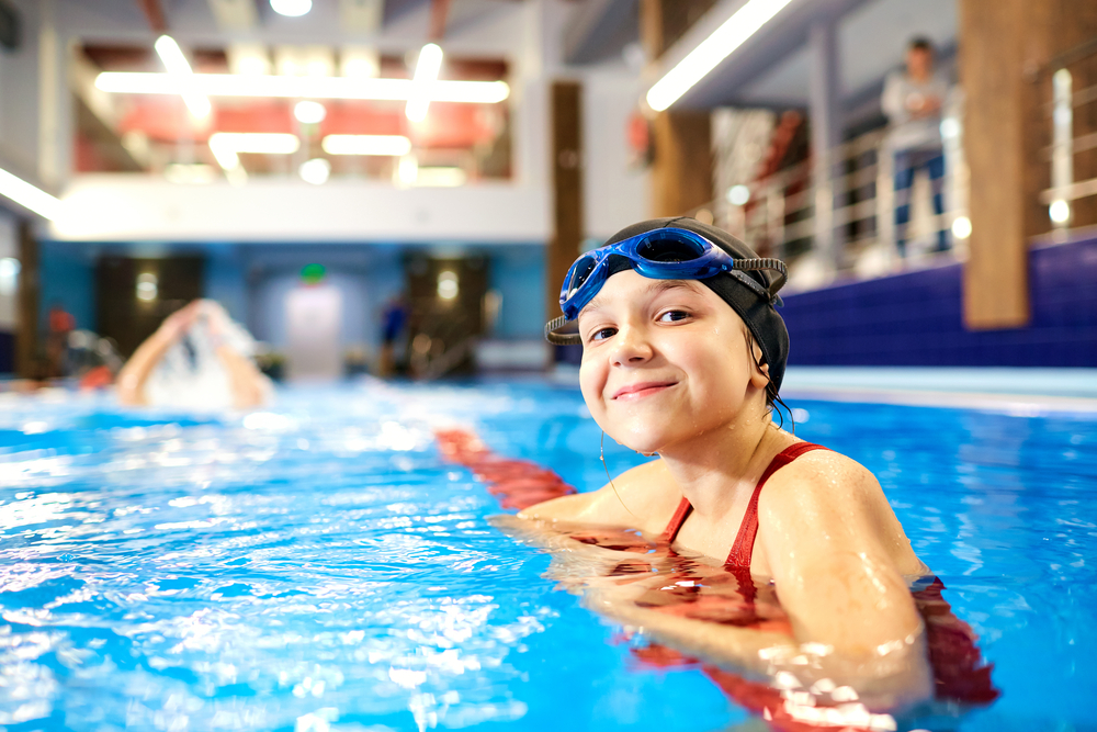 Image of smiling child in indoor pools in CT.