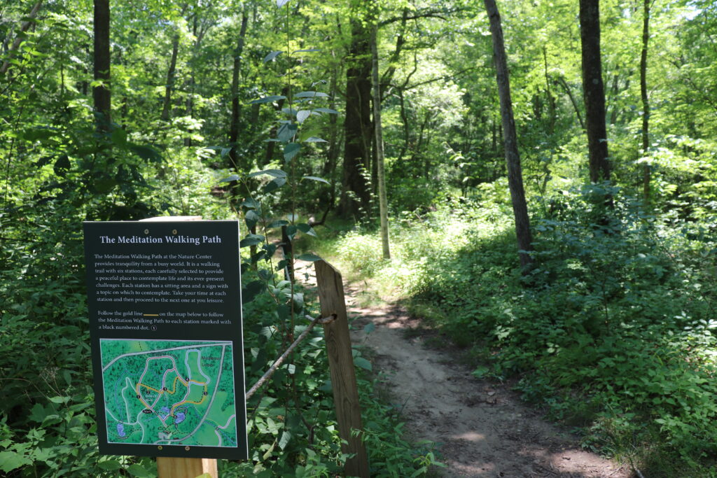 Image of walking path and sign at Pequot Nature Center.