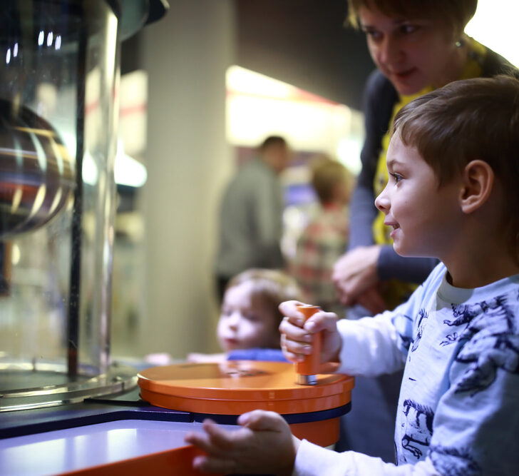 image of young boy doing activity at science museum, which is one of the CT attractions for families.
