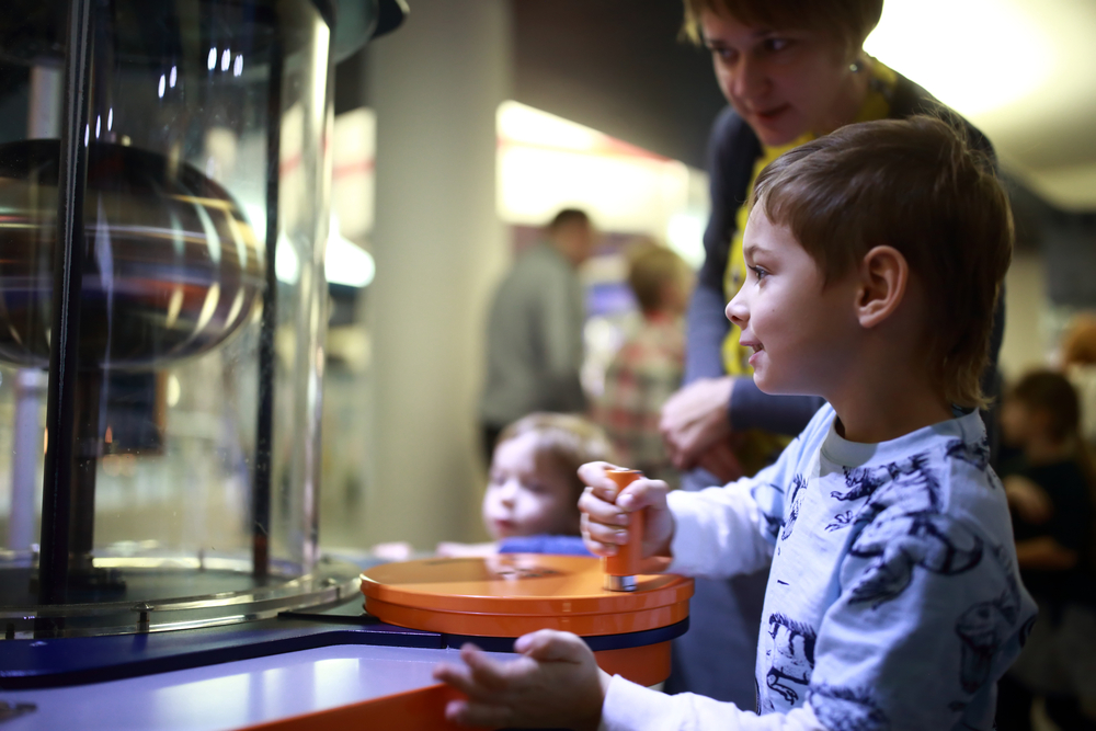 image of young boy doing activity at science museum, which is one of the CT attractions for families.