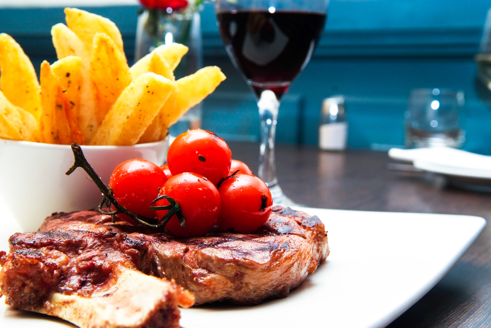 Image of a steak and tomatoes and french fries in the best steakhouse in CT.